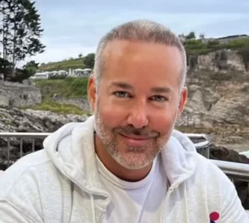 A grey-bearded man on the coast